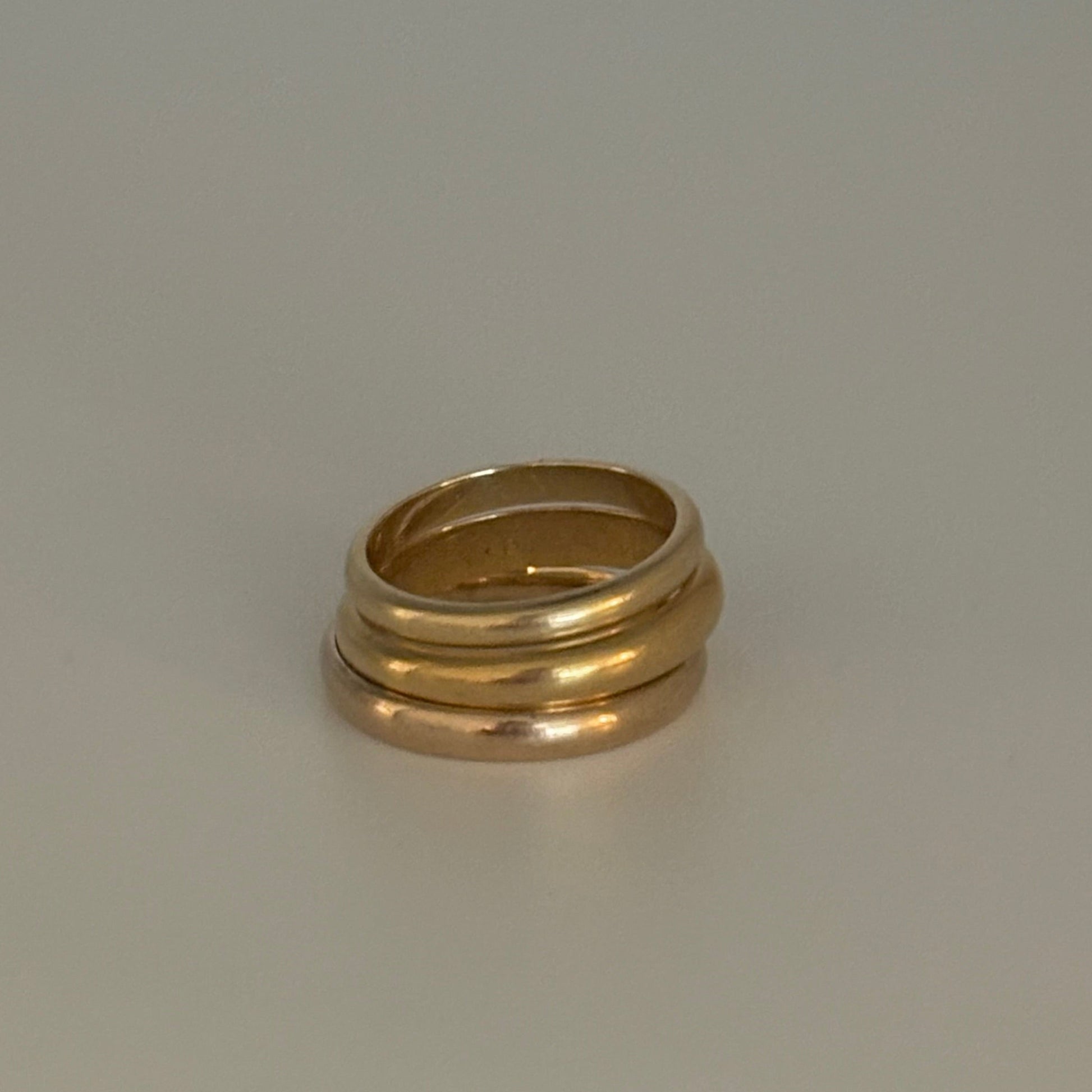 Gold ring on a light gray background