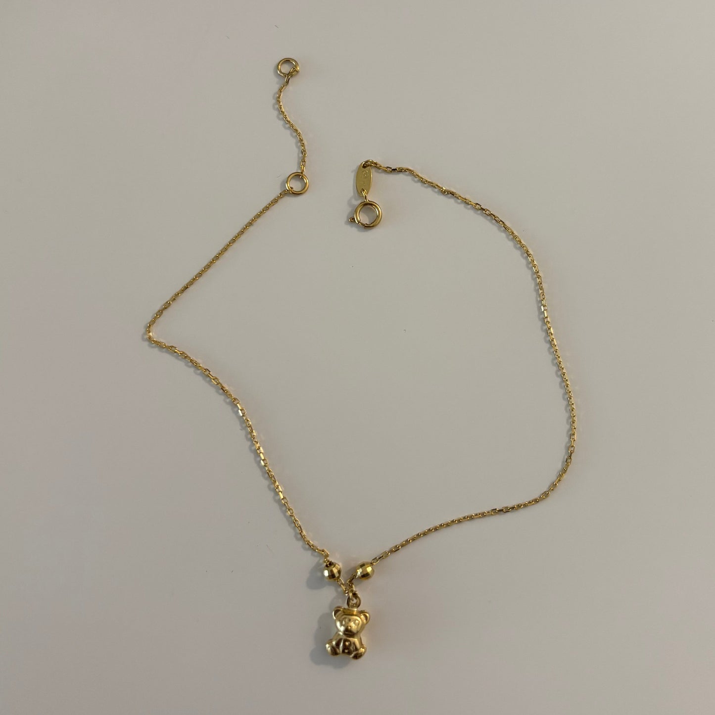 Gold bracelet on a white surface
