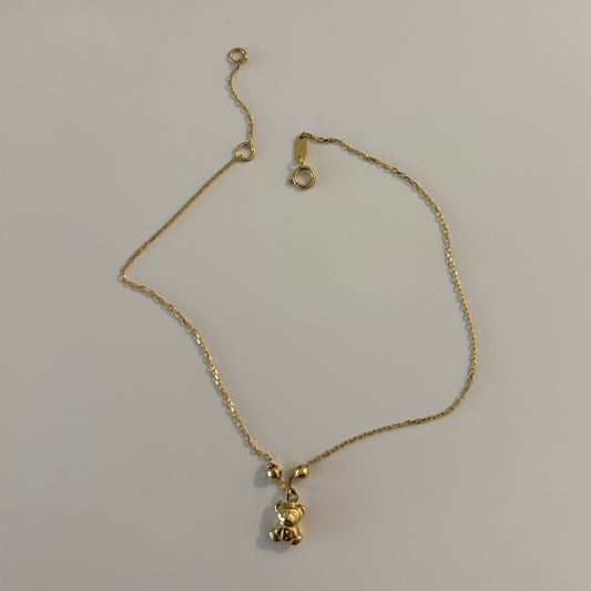 Gold bracelet on a white surface