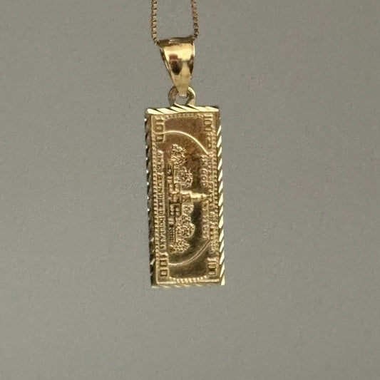 Gold dollar bill pendant on a gray background
