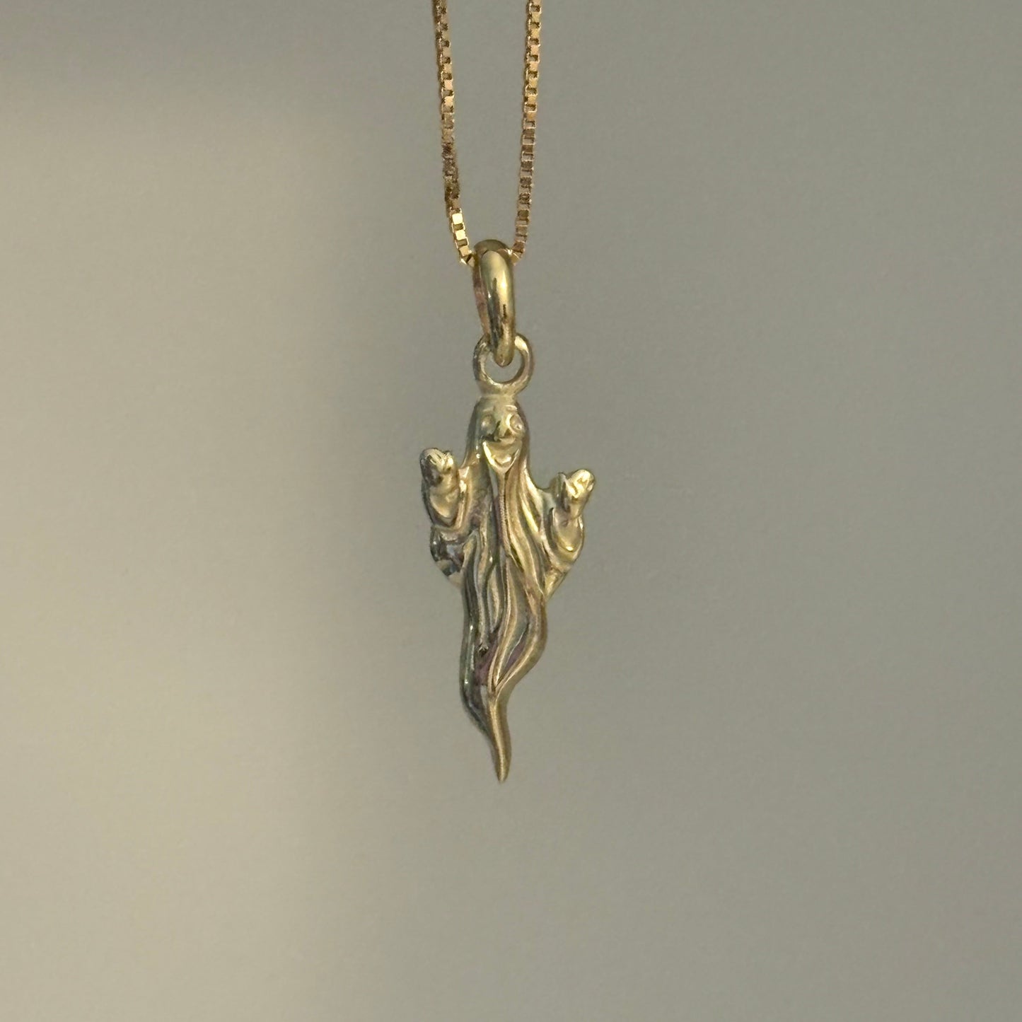 gold ghost charm with smiley face