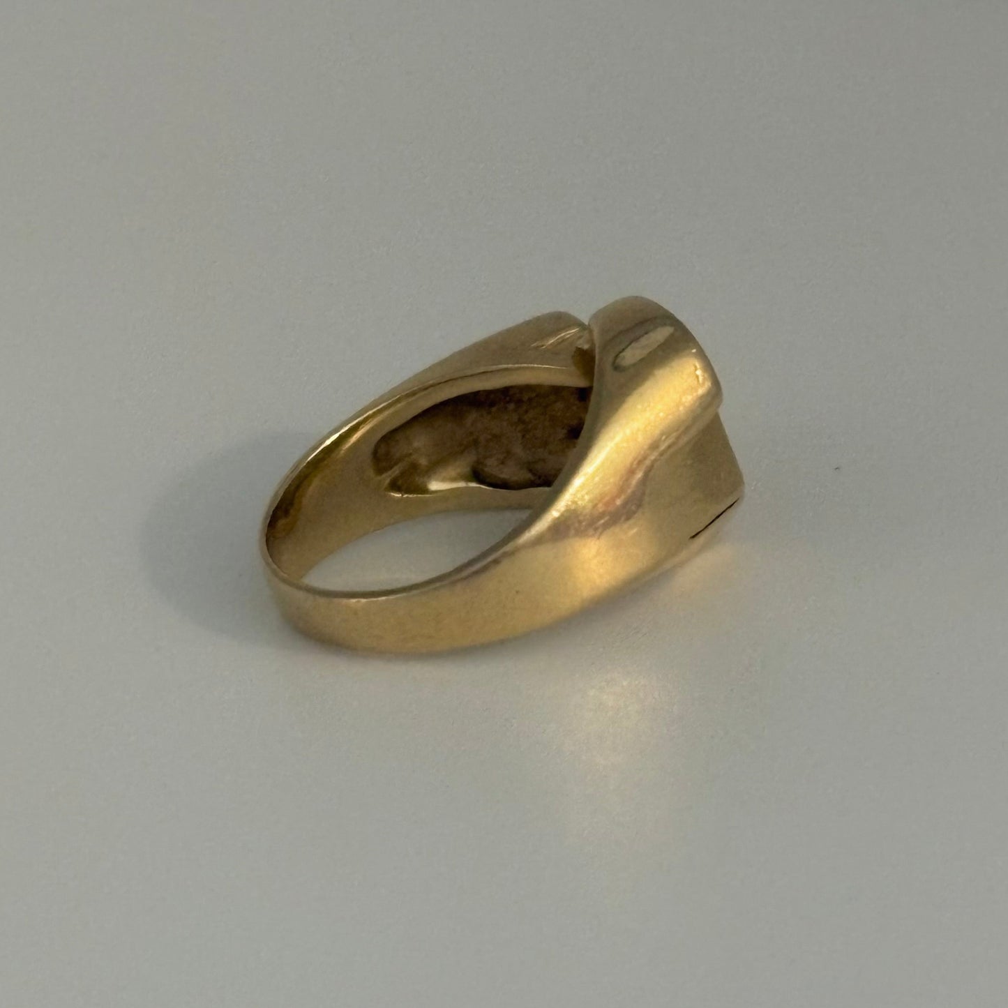 Gold ring on a gray background