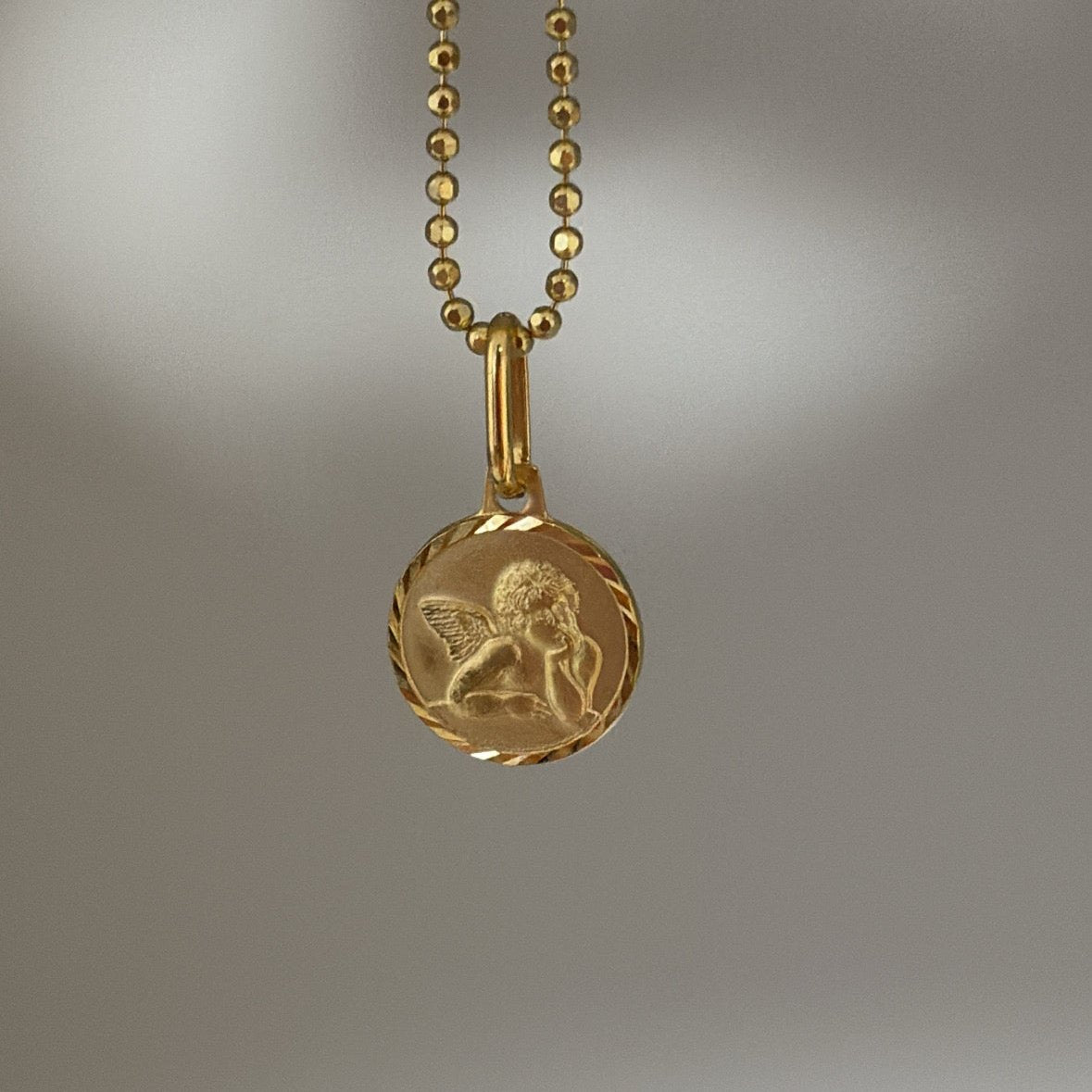 thinking cherub necklace