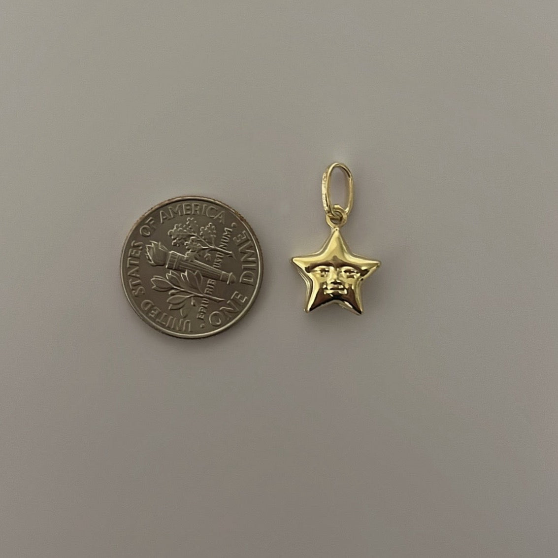 puffy star with face charm.