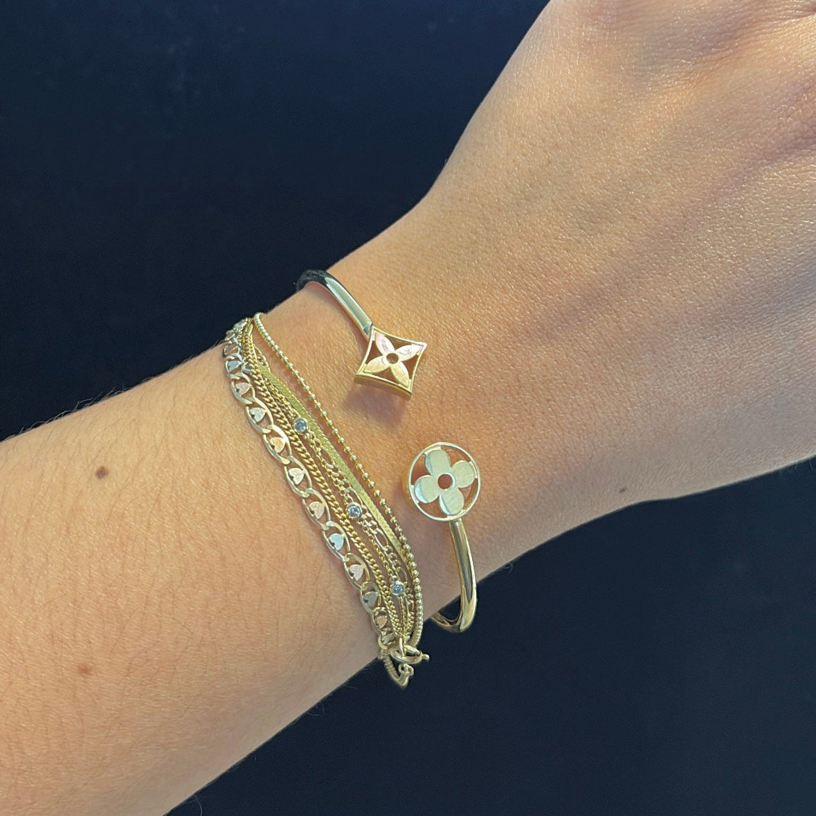 14k Hinged Cuff Bangle with Monogram Floral Motifs on wrist for reference 