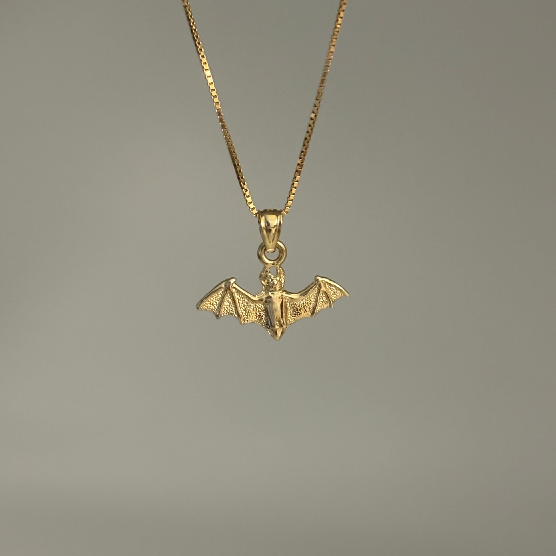 14K gold bat charm pendant with outstretched wings on chain