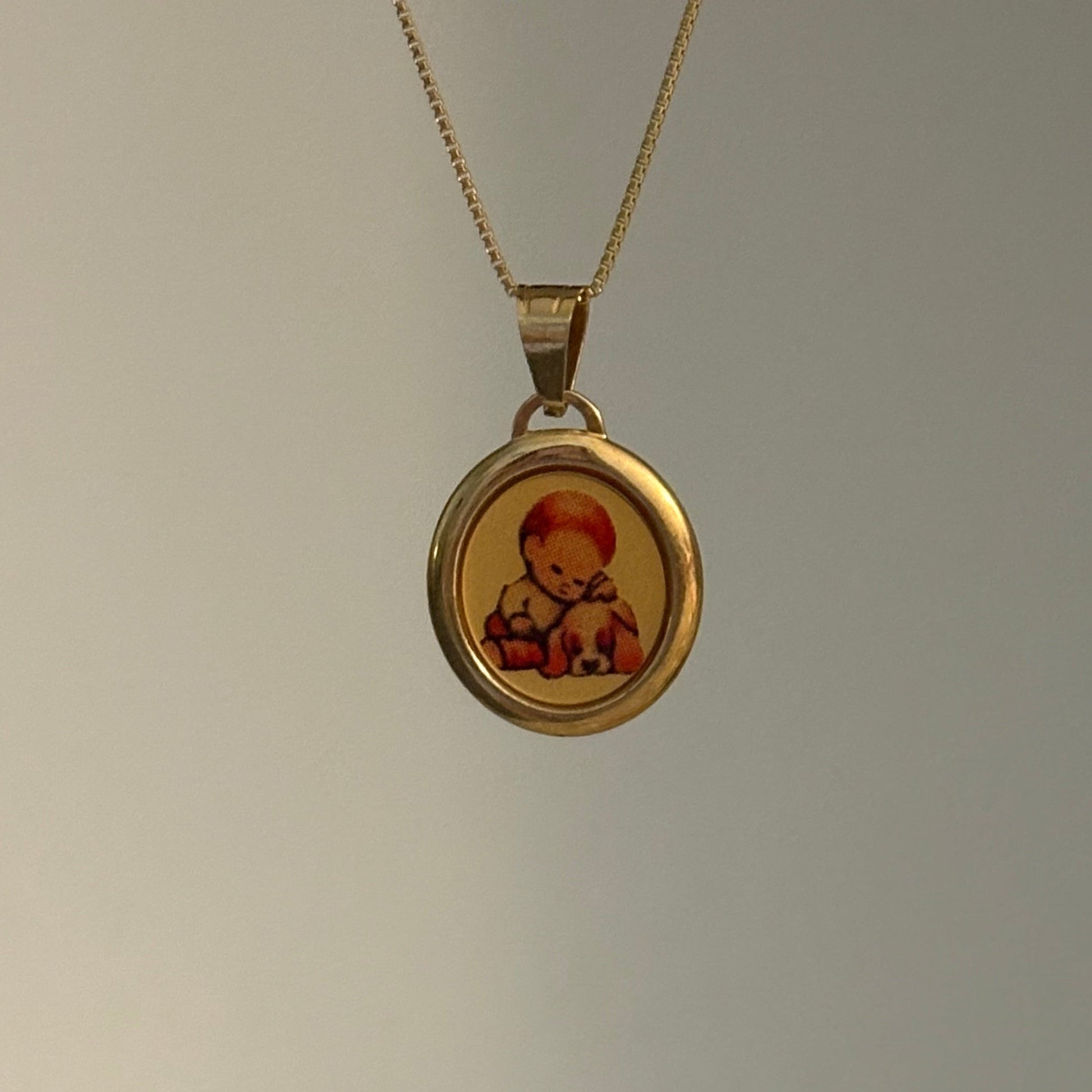 Vintage Italian 14K gold pendant featuring a young boy with his puppy, Italy 585.