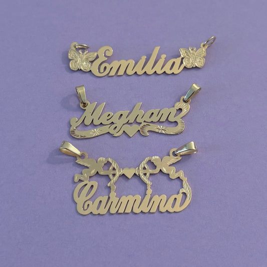 Gold name pendants on a purple surface