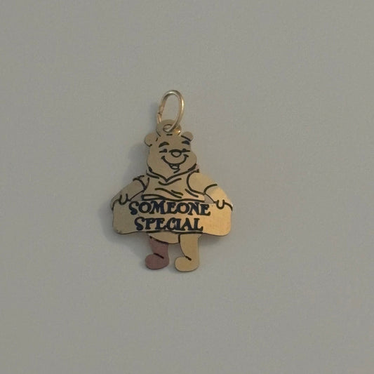 WINNIE THE POOH charm with a bear design and 'Someone Special' text on a gray background