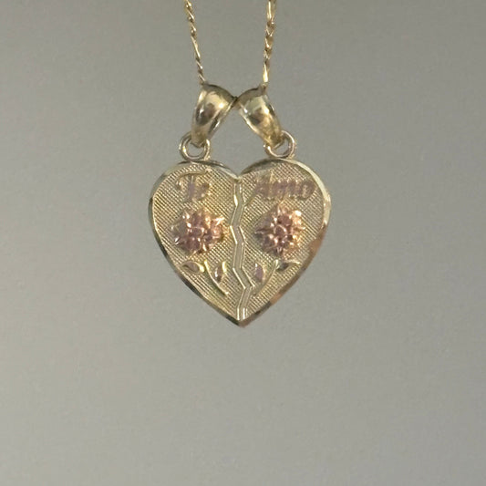 Gold heart-shaped pendant with chain on a gray background
