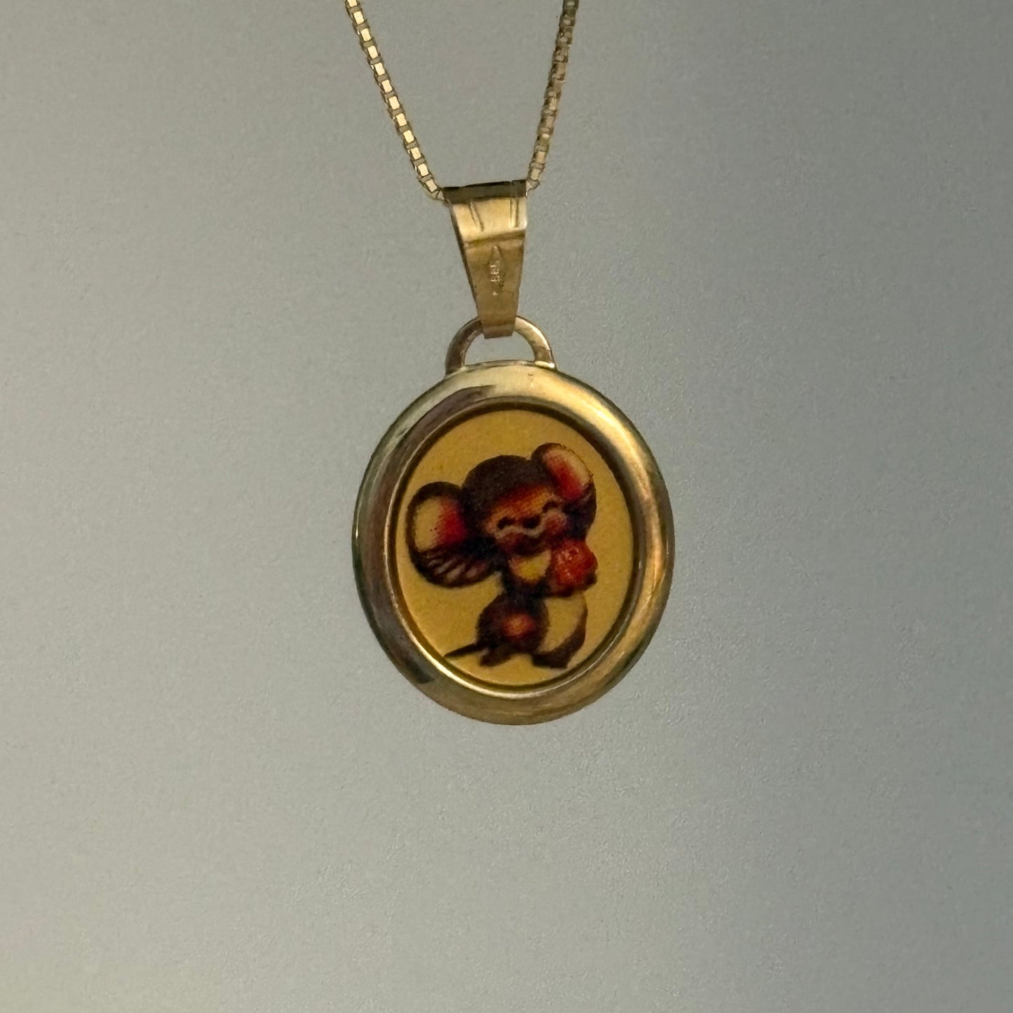 Vintage Italian 14K gold pendant featuring a mouse holding a strawberry, Italy 585.