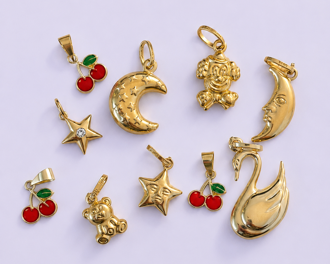Collection of gold pendants on a light purple background
