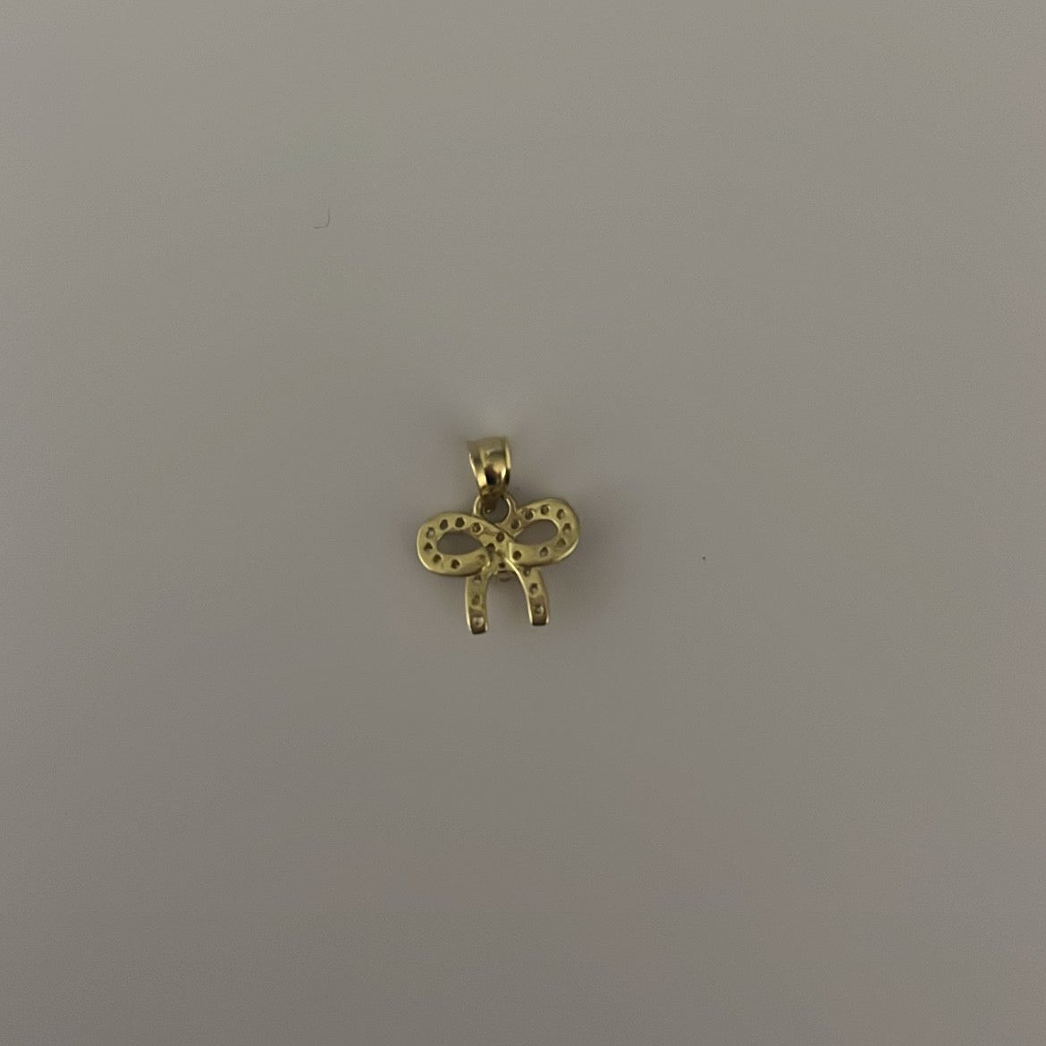 10K yellow solid gold CZ bow charm